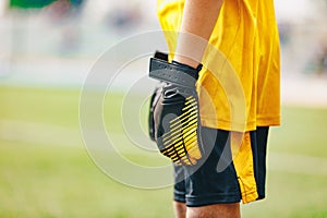 Close up of Soccer Gloves of Young Boy Soccer Goalie Standing in a Goal