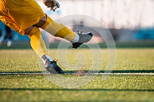 Close-up soccer goalkeeper kicks the ball into play