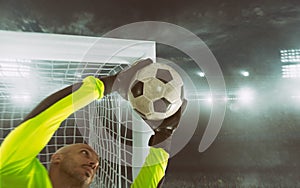 Close up of a soccer goalkeeper saving the ball at the corner of the goalposts