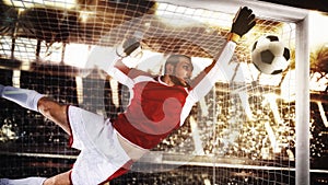 Close up of a soccer goalkeeper saving the ball at the corner of the goalposts