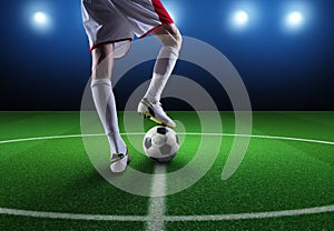 Close up of a soccer striker ready to kicks the ball at the stadium