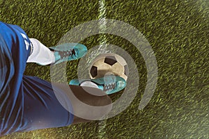 Close up of a soccer striker ready to kicks the ball at the stadium