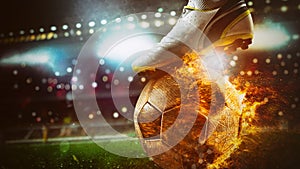 Close up of a soccer striker ready to kicks a fiery ball at the stadium