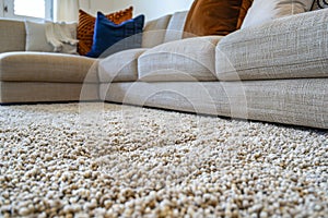 close up of sofa with beige carpet rug home interior background