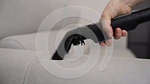 Close-up of sofa cleaning equipment. A woman cleans a dirty stain on the sofa. Professional Housekeeping Cleaning