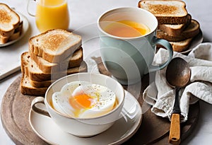A close-up of a soft boiled egg in a cup with a slice of toast on the side