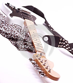 Close-up of soft fabric and a black and white electric guitar.i