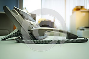 Close up soft focus on ip phone devices with space at office desk