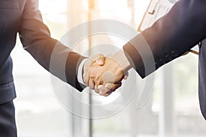 Close Up of soft focus two young business man hands people shaking hands, finishing up a meeting Greeting Deal Concept