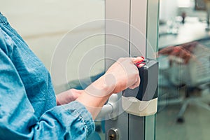 Close up soft focus on woman s hand scanning finger on electronic control machine to access the door. New modern technoligy concep