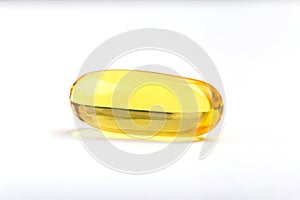 Close up a soft gel capsule on white background, natural fish oi
