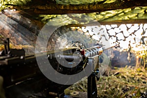 Close-up soldiers firing a 50 Cal Machine gun with spent brass around it