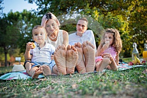 Close-up of the soles of the feet of a family during a picnic in a park