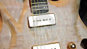Close up of a solid natural brown electric guitar