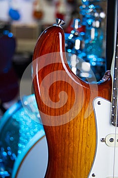 Close up of a solid sunburst from black to brown electric guitar