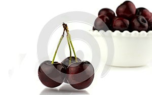 Close-up some cherries with stems. Isolated on white background