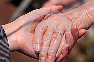 Close-up of some hands of an older person and a younger one