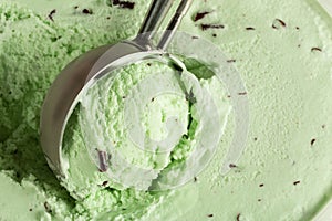 Close up of some mint chocolate chip ice cream being scooped