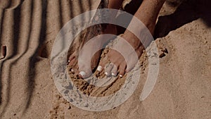 A close up of someones foot in the sand by the water on the beach