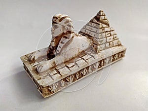 Close-up on a souvenir sphinx and pyramids from Egypt on a white background