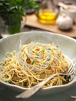 Close-up spaghetti AGLIO E OLIO and ingredients vertical frame