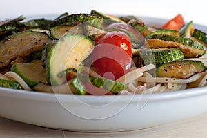 close up of spaghetti with fresh tomato and zucchini.