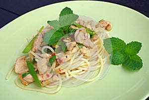 Close up spaghetti with pork on the green plate