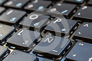 Close-up of Spanish laptop keyboard focus on button