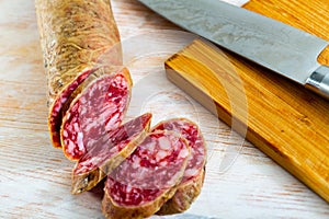 Close-up of spanish salchichon sausage at wooden surface