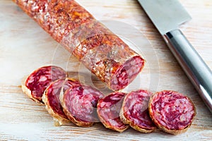 Close-up of spanish salchichon sausage at wooden surface