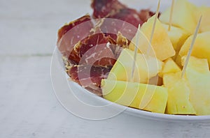 Close up of spanish serrano ham with melon