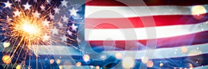 Close-up Of Sparkler With Bokeh And Smoke On American Flag Background
