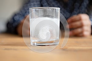 Close up sparkling water glass with dissolving effervescent pill
