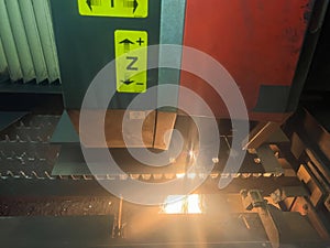 Close up of sparks fly out machine head for metal processing at the factory. Automotive production concept