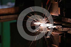 Sparks fly out machine head for metal processing laser metal