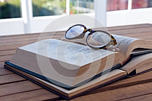 Close-up of spectacles on open book