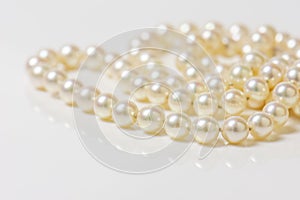 Close up of sphere natural pearl necklace on white background. Selective focus.