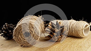 Close up, Spool of Hemp Twine Rotation on a Wooden Board, Black Background