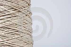 Close-up of a spool of thread macro texture isolated on white background with copy space