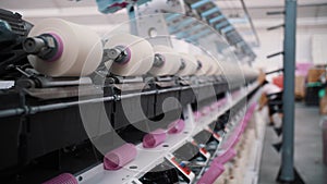 Close-up spools of yarn thread. Spinning production. Yarn making processes. Textile factory equipment. Threads