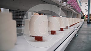 Close-up spools of yarn thread. Textile factory. Spinning production. Threads production. Yarn making processes. Textile