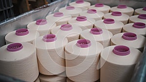 Close-up spools of yarn thread. Textile factory. Yarn making processes. Threads production. Spinning production. Textile