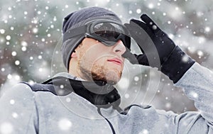 Close up of sports man with ski goggles in winter