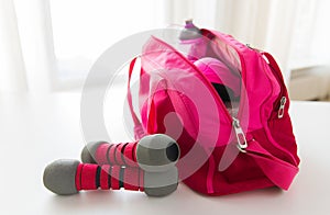 Close up of sports stuff in bag and dumbbells