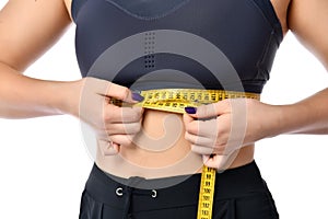 Close up of a sports woman`s waist on a white background.