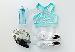 Close up of sportswear, skipping rope and bottle