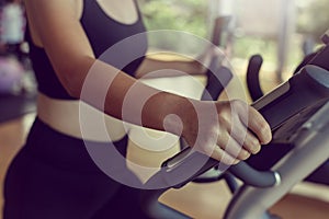 Close-up Sportwoman walking or running on treadmill equipment in fitness workout gym.Concept fitness ,workout, gym exercise ,