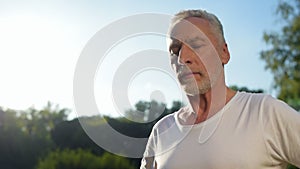 Close up of a sporty aged man doing warm up exercises