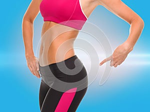 Close up of sporty woman pointing at her buttocks