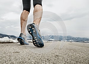 Close up sprinter legs on asphalt